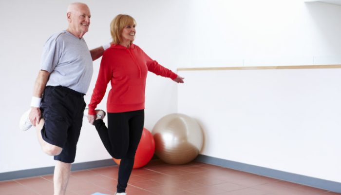 Senior Couple Balancing on One Leg